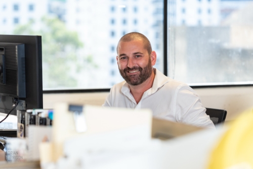 Corporate lifestyle photography of a man at his desk in his Chatswood, Sydney office. 
