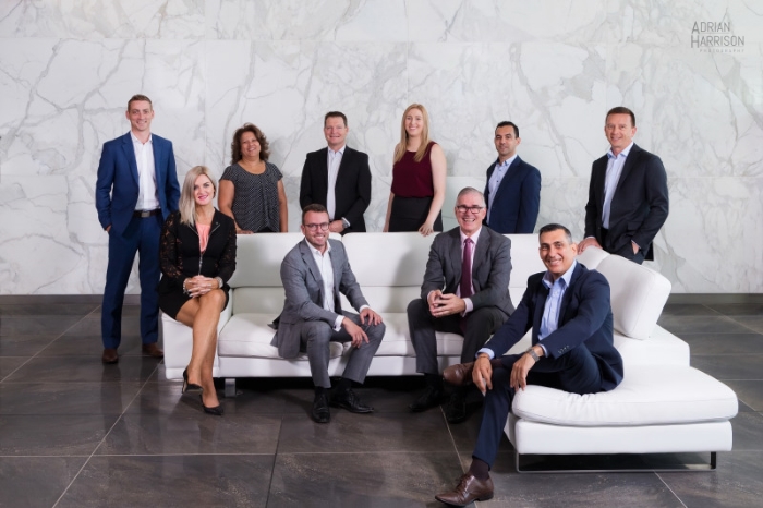 Corporate group photography of business people sitting on a lounge.