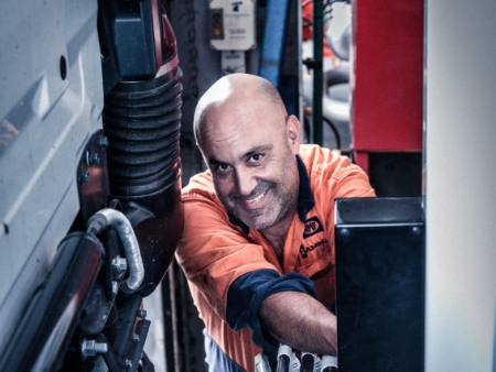commercial photo of a man working on industrial machinery.