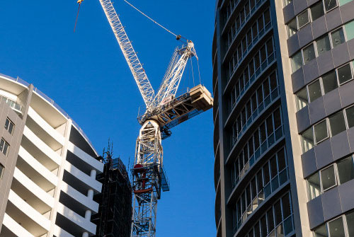 Tower crane working on two high rise apartment buildings in Castle Hill. Photographed by construction photographer Adrian Harrison.