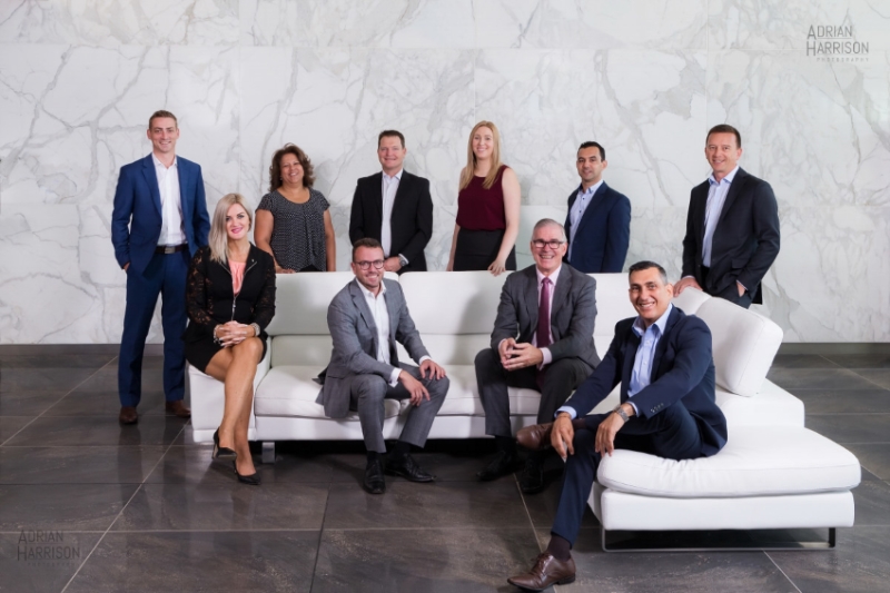 Corporate group or team photography in Norwest, Sydney. Team group of men and women sitting and standing.