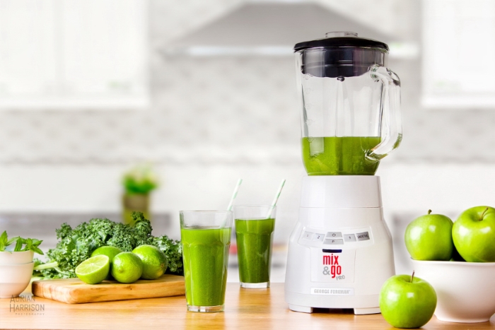 Lifestyle product photography of a blender in a kitchen styled with drinks and food.