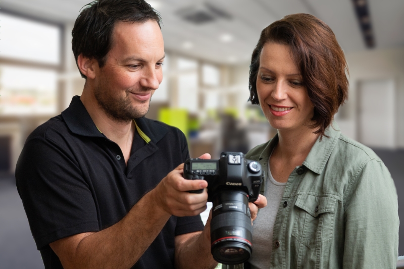 Sydney's best architectural photographer Adrian Harrison showing a client photos on a camera.