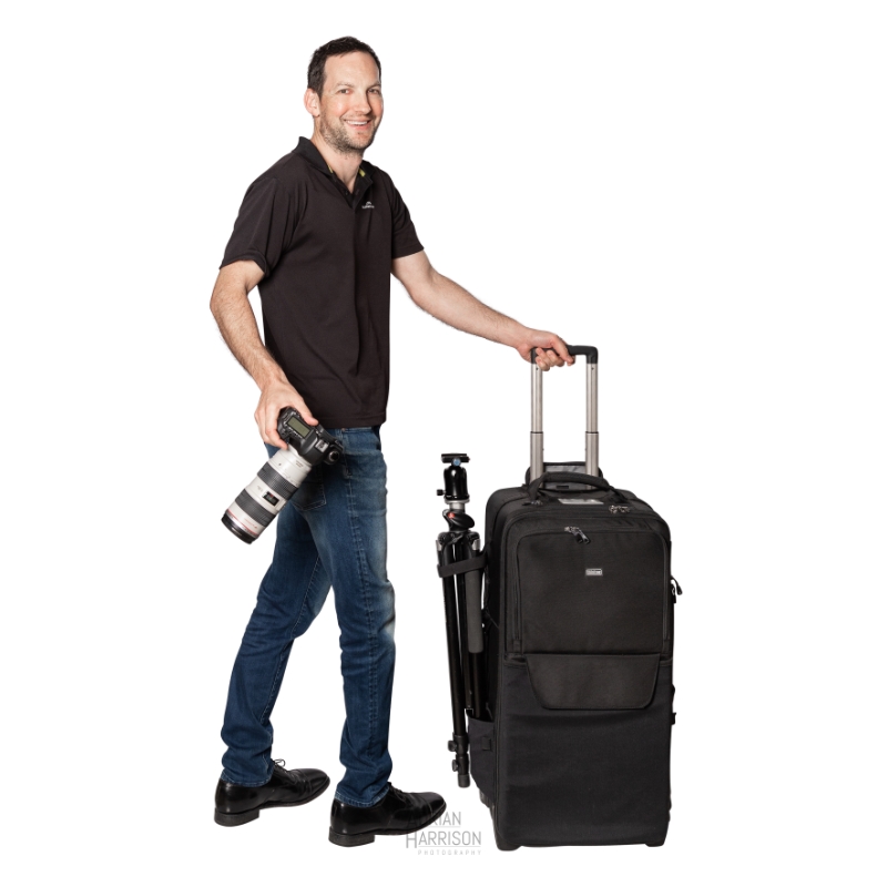 Sydney based ecommerce product photographer Adrian Harrison with camera, camera bag and tripod ready to travel for a photoshoot.