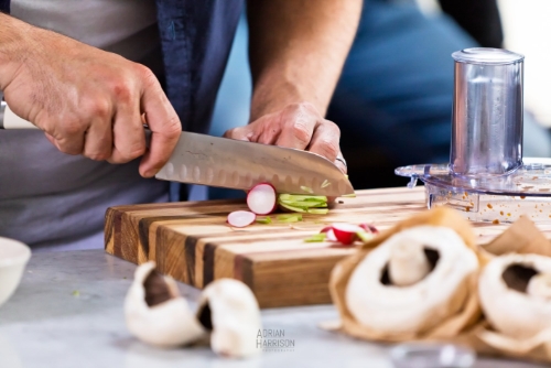 Closeup of chef slicing food.